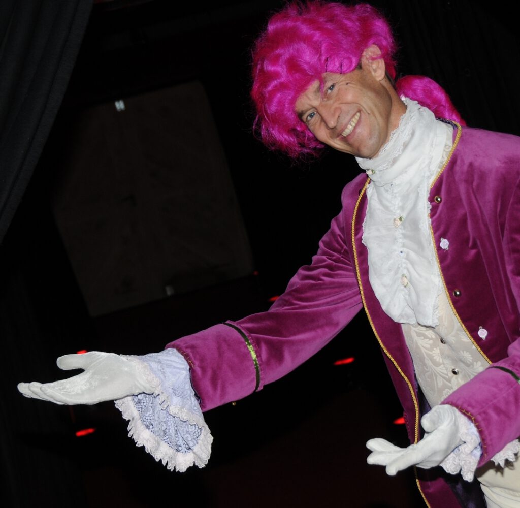 Lachende lakei wijst met beide handen.